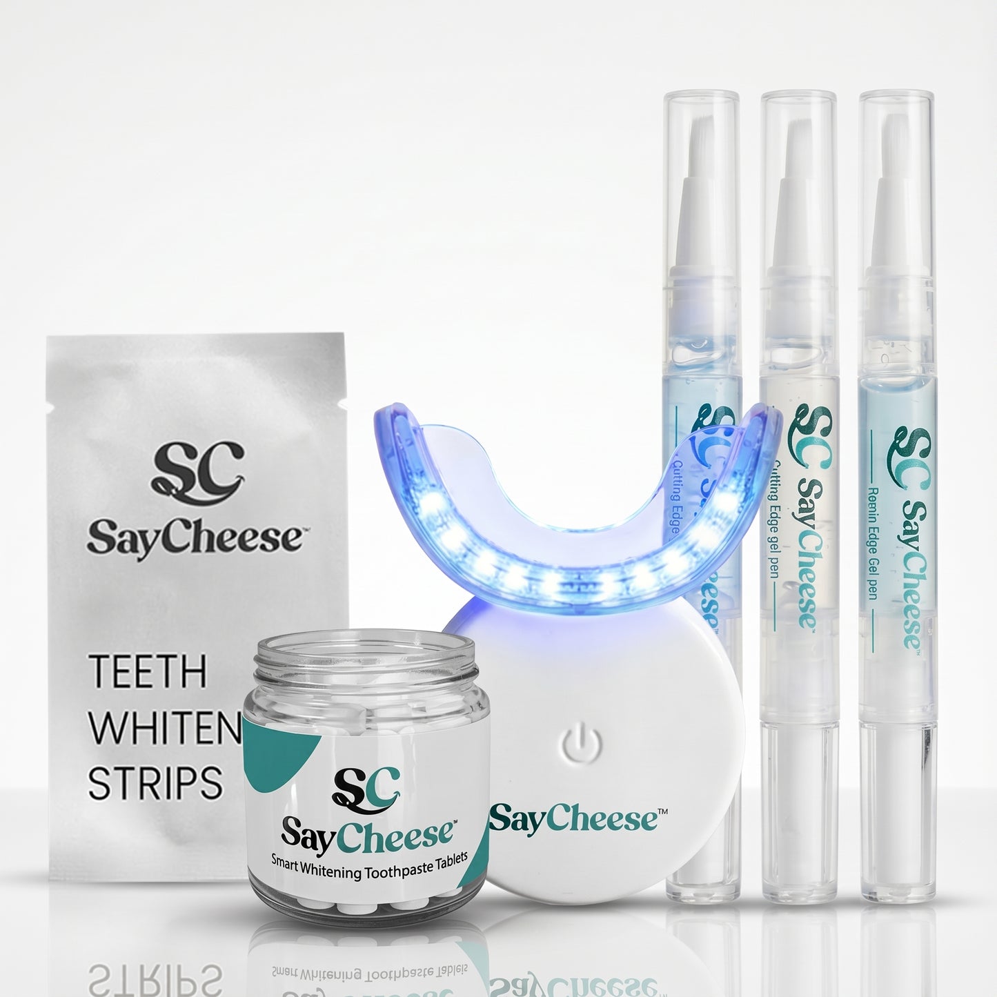 SayCheese teeth whitening product set including strips, gel, and light on a white background